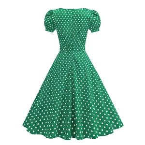 Detailed back view of vintage green polka dot dress with short puff sleeves