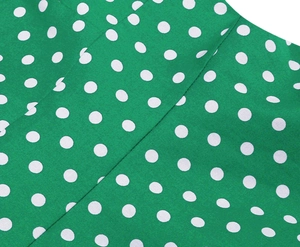 Close-up of green polka dot fabric showing detailed stitching and high-quality textile texture