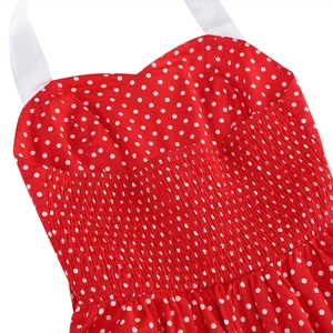 Detailed view of red polka dot dress featuring smocked waist and halter neck straps