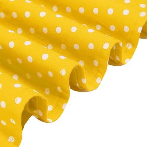 Detailaufnahme von gelbem Polka-Dot-Stoff mit Rüschen an einem Vintage-ärmellosen Kleid