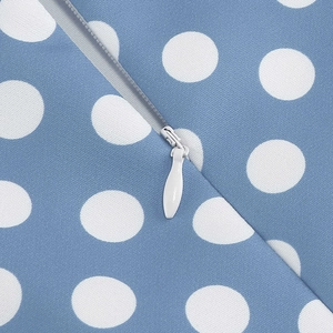 Detailed close-up of a concealed zipper on blue and white polka dot woven fabric