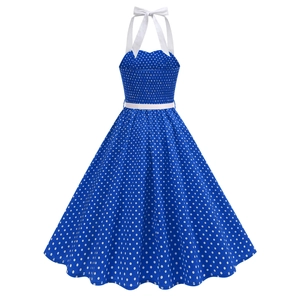 Detail of royal blue polka dot retro dress with halter neck tie and thin white waist belt