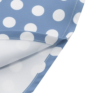 Detailed view of light blue polka dot fabric texture and precision hem stitching on the dress