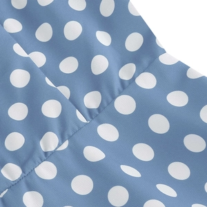 Macro shot of light blue polka dot dress fabric showing seam detail and cotton texture