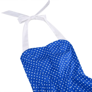 Detail of blue polka dot halter dress featuring a large white neck tie bow fastening
