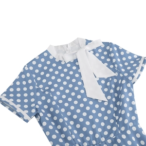 Detail of light blue vintage polka dot dress showing neckline with a white bow tie