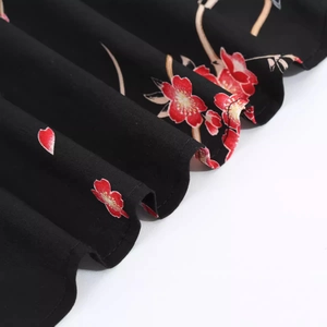 Retro V-neck short sleeve dress with red floral print on a black flowing fabric skirt