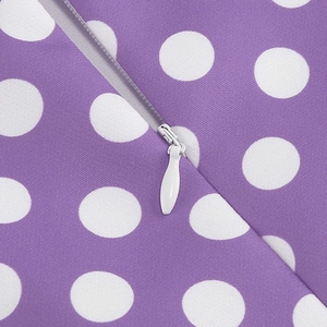 Detailed close-up of a hidden zipper on a purple polka dot vintage dress fabric