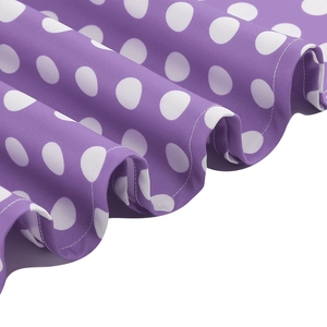 Detail of purple fabric with white polka dots featuring pleated hem and precise stitching