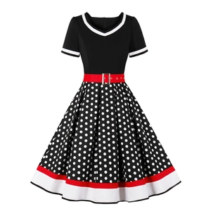 Vintage 1950s rockabilly swing dress with red belt and black white polka dot pattern