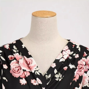 Retro V-neck short sleeve dress with rose floral print on black silky fabric displayed on a mannequin