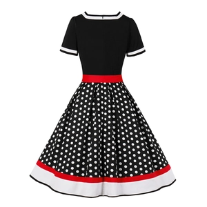 Detail of vintage 50s Hepburn style dress with polka dot pattern and a red waist belt