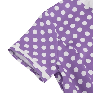 Detailed close-up of purple polka dot dress sleeve with white ribbon edge and fine stitching