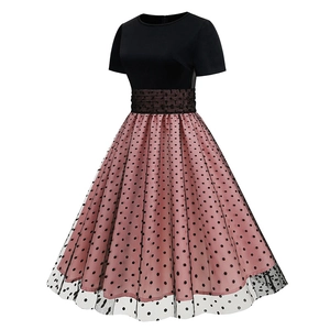 Detail of the vintage A-line dress featuring black polka dot mesh over pink fabric