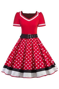 Close-up of retro red polka dot dress featuring a V-neckline and black contrast belt