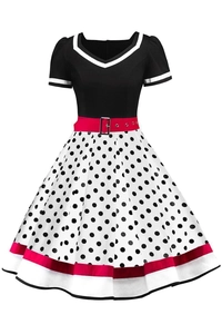 Close-up of vintage Audrey Hepburn style dress with polka dots and red belt detail