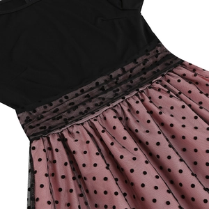 Detail of polka dot mesh waist and pleated skirt on a vintage round neck dress