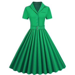Detail of emerald green vintage dress featuring notch lapel, buttons and matching belt