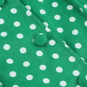 Vintage green polka dot sleeveless dress with matching fabric buttons and flat collar