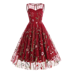 Detailed view of intricate floral embroidery on a vintage burgundy mesh A-line dress