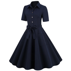Detail view of navy retro A-line dress featuring gold buttons and waist tie belt