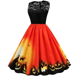 Detail of Halloween dress with lace bodice and pumpkin print on orange gradient skirt