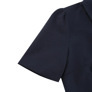 Detail of short puff sleeves on a navy blue vintage dress with delicate woven fabric