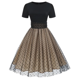 Vintage 1950s style polka dot dress with black short sleeve top and high waist mesh skirt