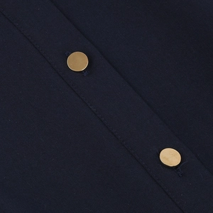 Close-up of vintage navy blue dress featuring twill fabric and gold metal buttons