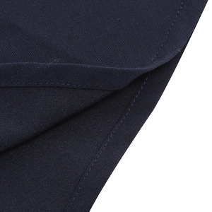 Detail of navy blue twill fabric with precise single-needle stitching on the hemline