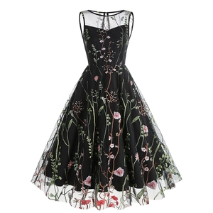 Close-up of intricate floral embroidery on black mesh fabric of sleeveless dress