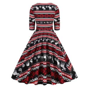 Detail of vintage Christmas swing dress with festive reindeer and snowflake prints