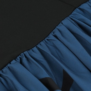 Detail of black ribbed knit fabric spliced with dark blue pleated dress material