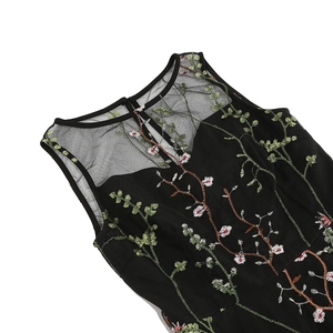 Detail of floral embroidery on black mesh neckline and bodice of sleeveless dress