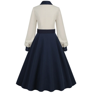 Back view of a 50s vintage style black and white patchwork dress with flared hem and waist belt
