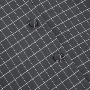 Detail of dark grey plaid fabric showing fine stitching and fabric-covered buttons