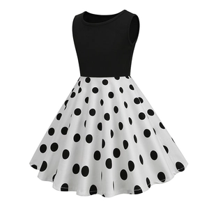 Retro girls sleeveless dress featuring black bodice and white polka dot print skirt