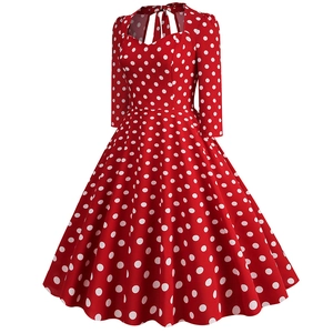 Detail of red rockabilly dress featuring white polka dots and a sweet bow tie neckline