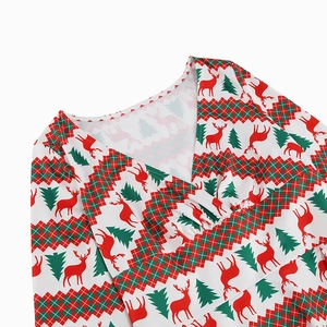 Detail of V-neckline with Christmas reindeer and plaid print on festive dress