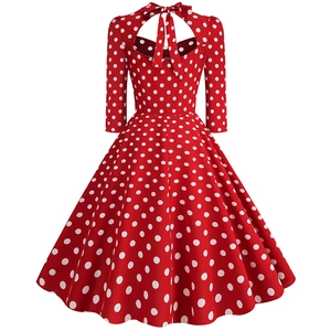 Detail of red polka dot vintage dress featuring a back bow tie and heart cutout