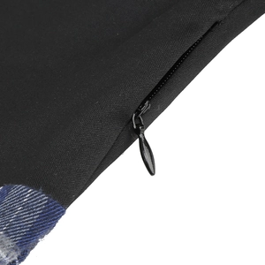 Detail of invisible zipper on black twill fabric with blue and white plaid lining