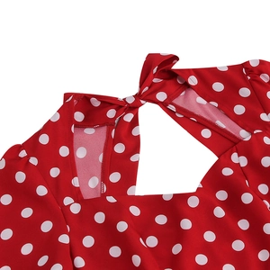 Detail of red polka dot vintage dress featuring a back bow tie and triangle cutout detail