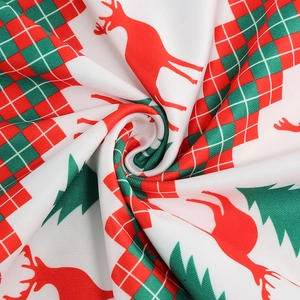 Detail of Christmas fabric with reindeer and tree patterns in vintage 50s style