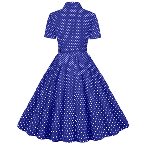 Flat lay back view of a vintage navy blue polka dot A-line dress with short sleeves