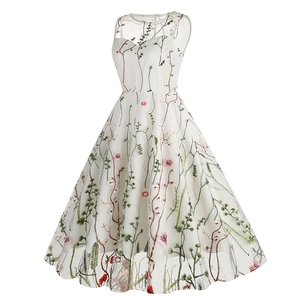 Close-up of intricate floral embroidery on white mesh sleeveless summer cocktail dress