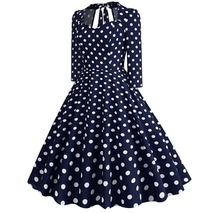 Detail of the back neckline featuring a bow tie on this vintage navy polka dot dress