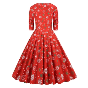 Rear view of a red long-sleeved Christmas dress with festive white and green snowflake patterns