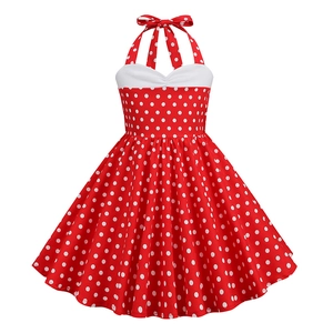 Detail view of red vintage girls dress with white polka dots and halter neck bow design