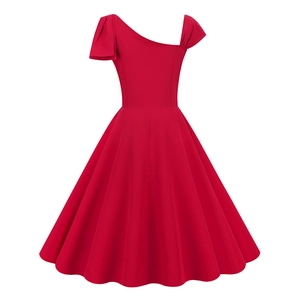 Detail of the red one-shoulder dress with a decorative shoulder bow and flared hemline