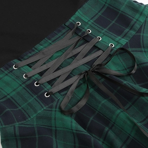 Detail of the vintage corsage lacing on a green and black plaid dress waist
